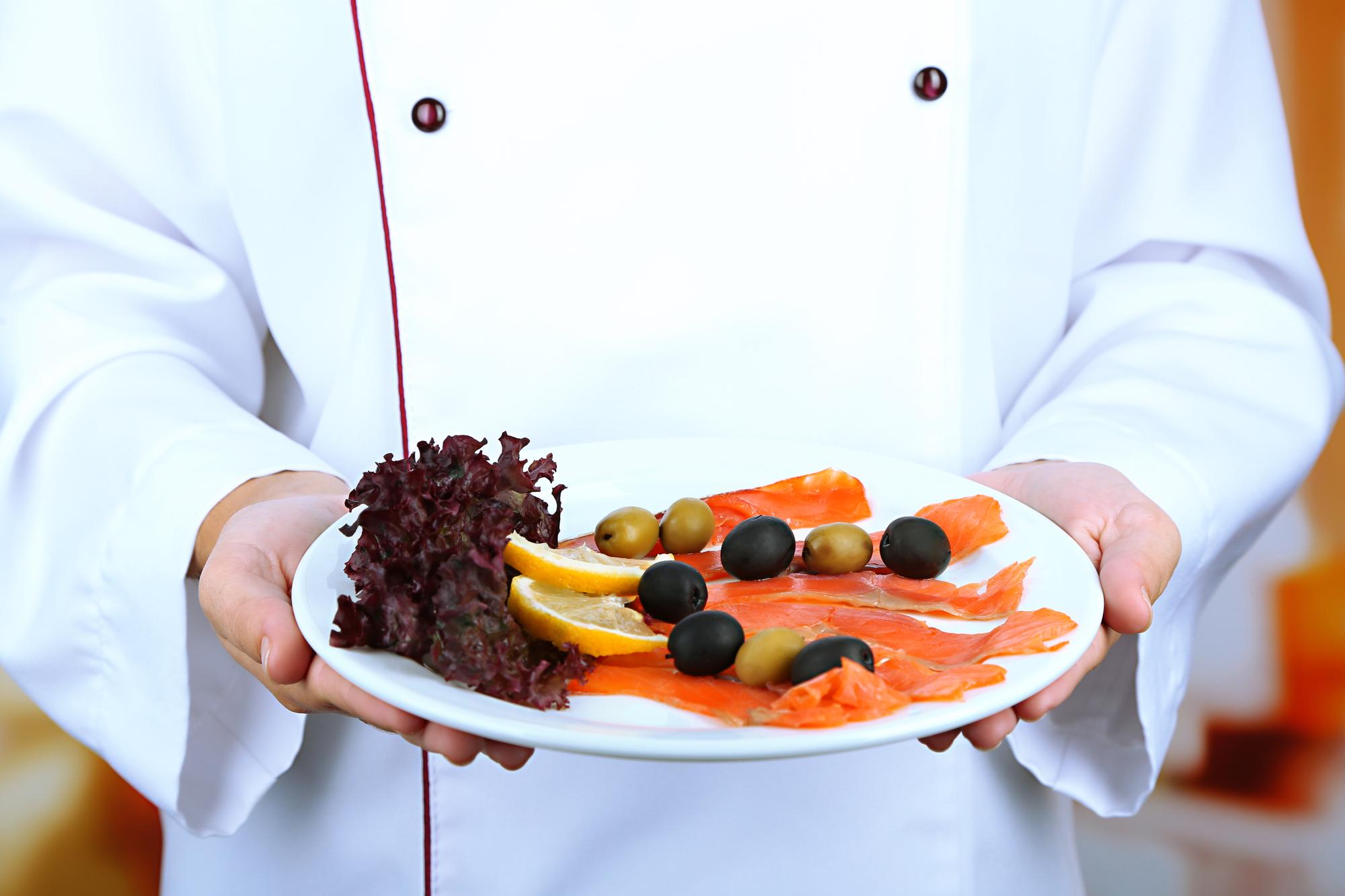 Chef showing plated dish to students