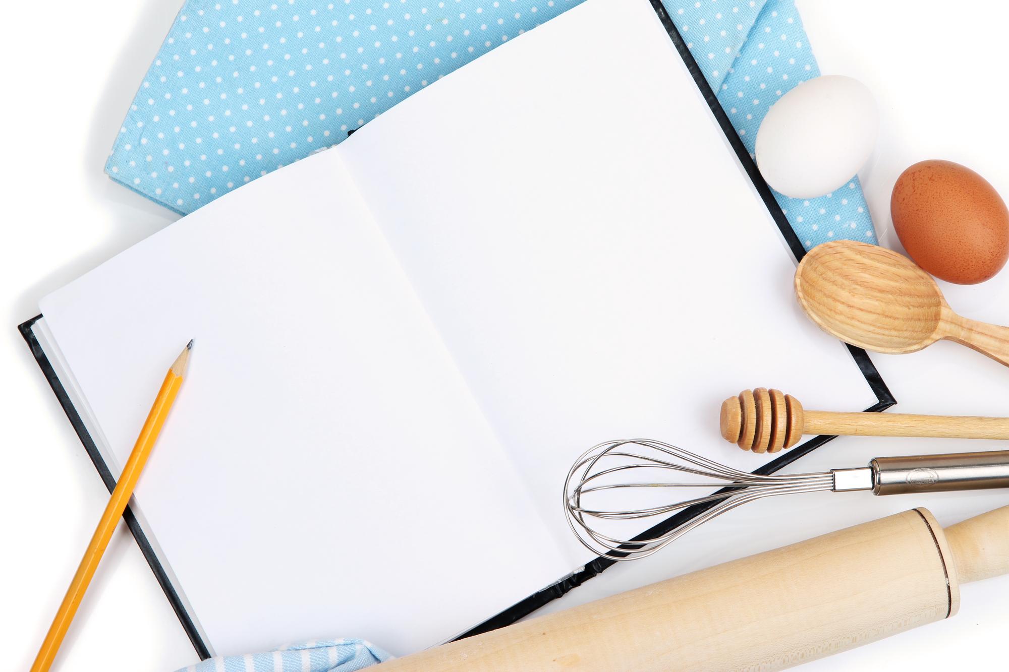 Stylized flatlay of cooking utensils and recipe cards